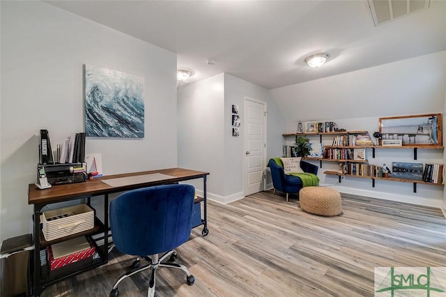 office area with vaulted ceiling and light wood-type flooring