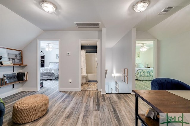 interior space with hardwood / wood-style floors and lofted ceiling