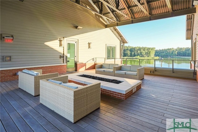 deck with a water view and an outdoor living space with a fire pit