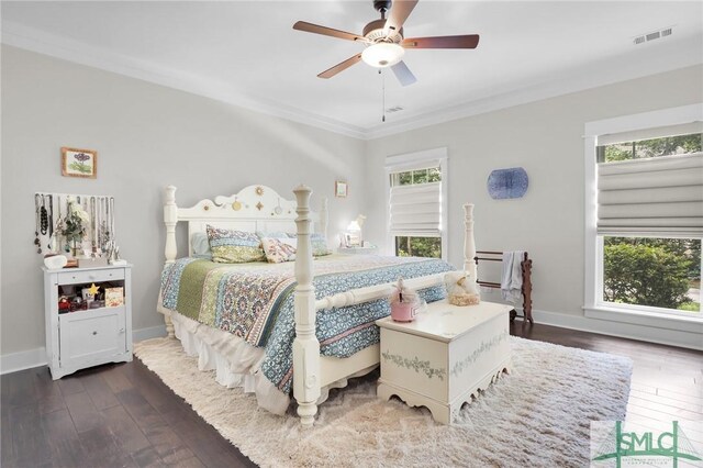 bedroom featuring multiple windows, ceiling fan, crown molding, and dark wood-type flooring