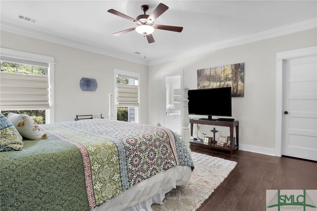 bedroom with ceiling fan, dark hardwood / wood-style flooring, crown molding, and connected bathroom