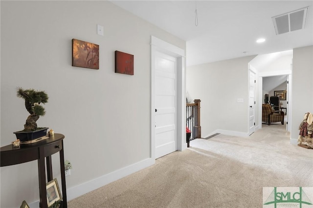 corridor featuring light colored carpet