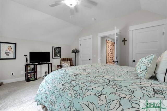 carpeted bedroom with ceiling fan and lofted ceiling