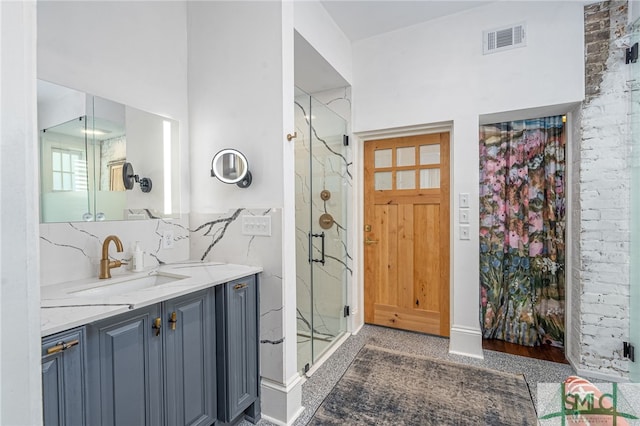 bathroom featuring vanity, walk in shower, and backsplash