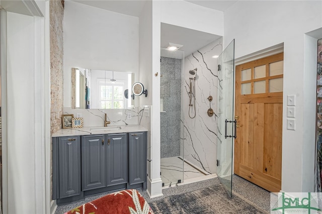 bathroom with a shower with door and vanity