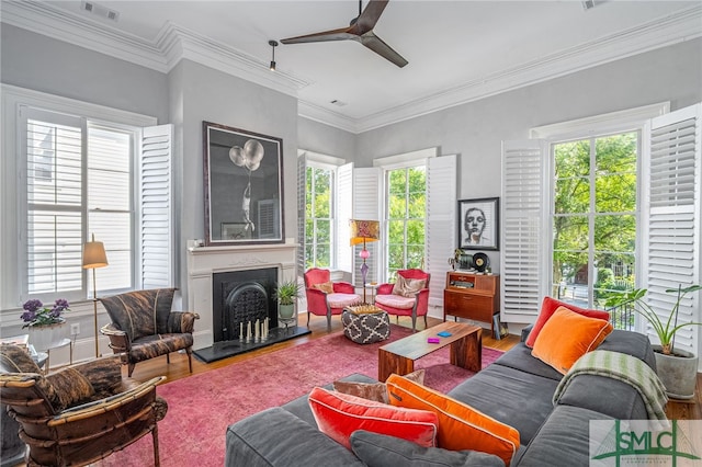 living room featuring hardwood / wood-style floors, plenty of natural light, and crown molding