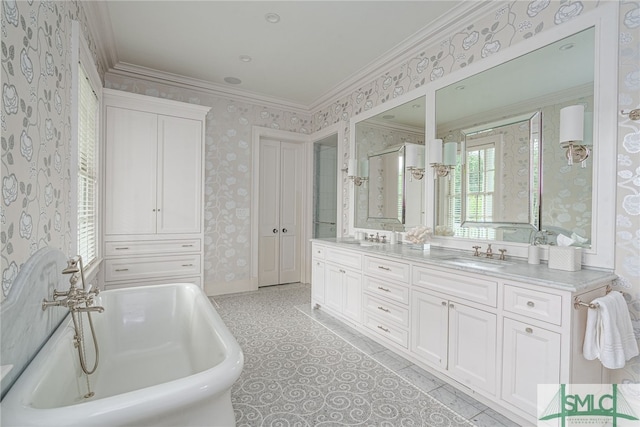 bathroom with vanity, ornamental molding, and a bath