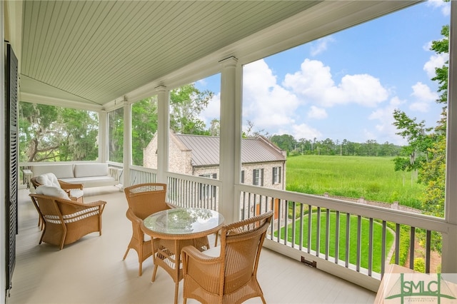 sunroom featuring lofted ceiling