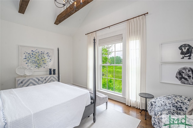 bedroom with lofted ceiling with beams and hardwood / wood-style flooring