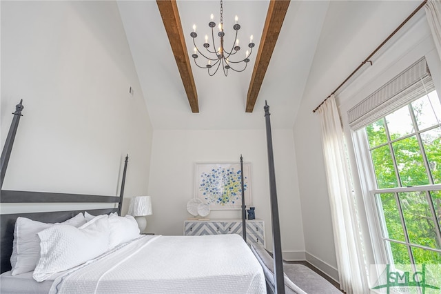 bedroom with lofted ceiling with beams and a chandelier