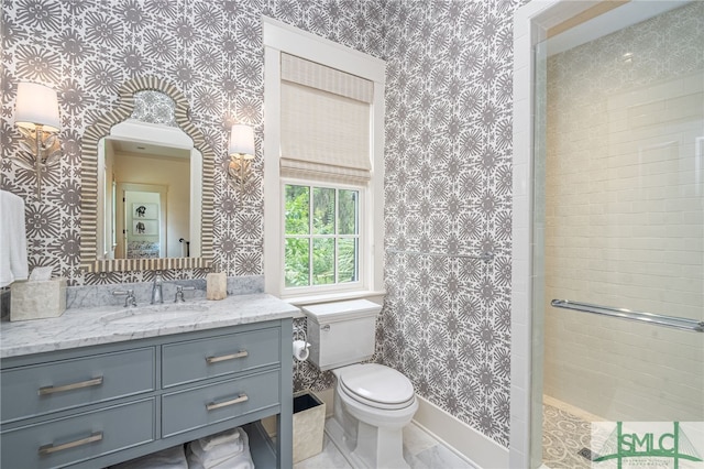 bathroom featuring vanity, toilet, and a shower with door