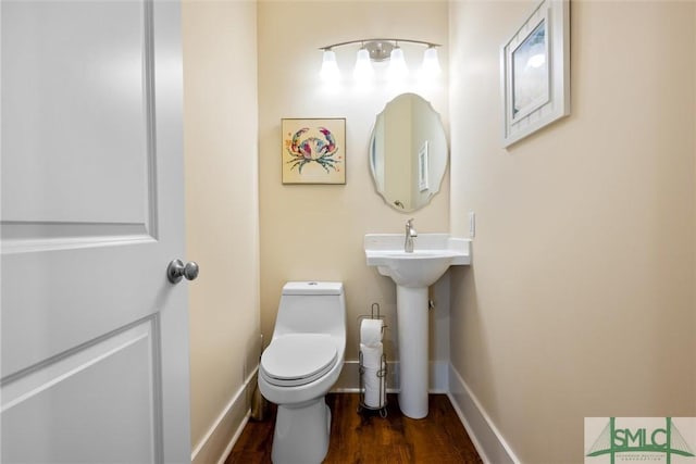 bathroom with sink, toilet, and hardwood / wood-style floors