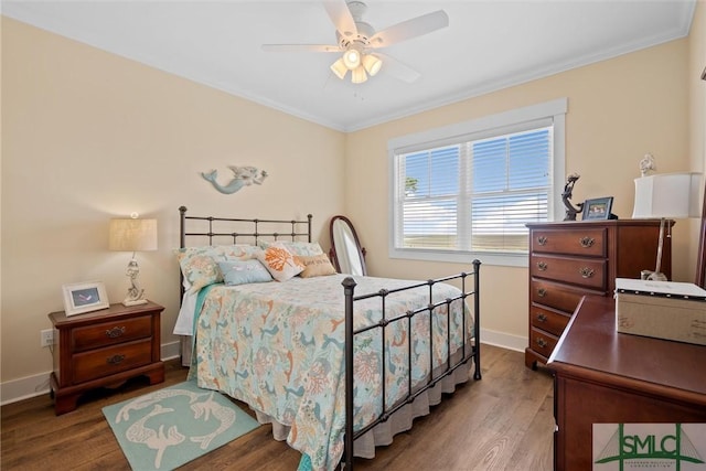 bedroom with crown molding, wood-type flooring, and ceiling fan