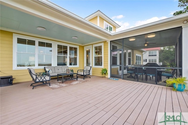 deck with an outdoor living space, a sunroom, and ceiling fan