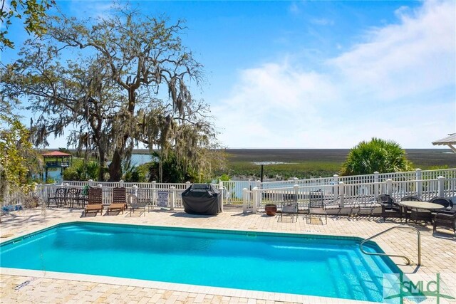 view of swimming pool with a patio area