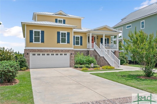 view of front facade with covered porch, a front yard, and a garage