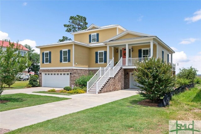 view of front of house with a front yard, a porch, and a garage