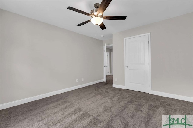 empty room featuring dark carpet and ceiling fan