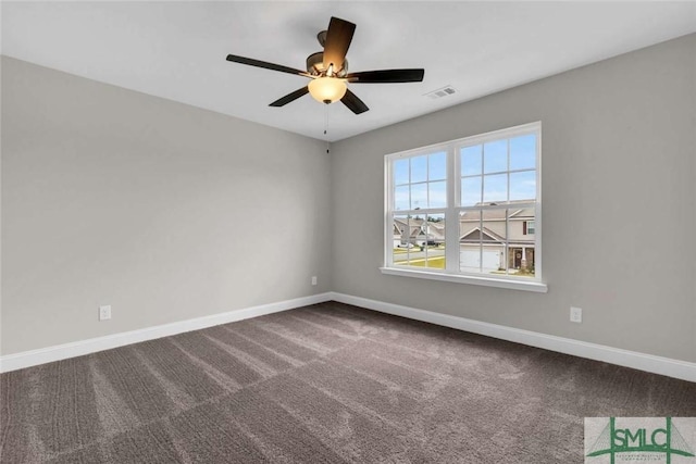 unfurnished room featuring carpet flooring, ceiling fan, visible vents, and baseboards