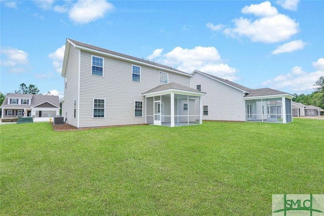 back of property featuring a sunroom, central AC unit, and a lawn