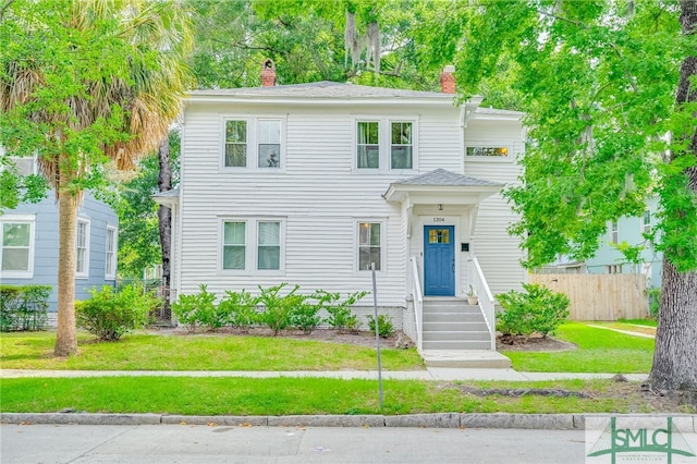 view of front of property with a front lawn