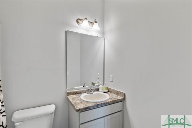 bathroom with oversized vanity and toilet