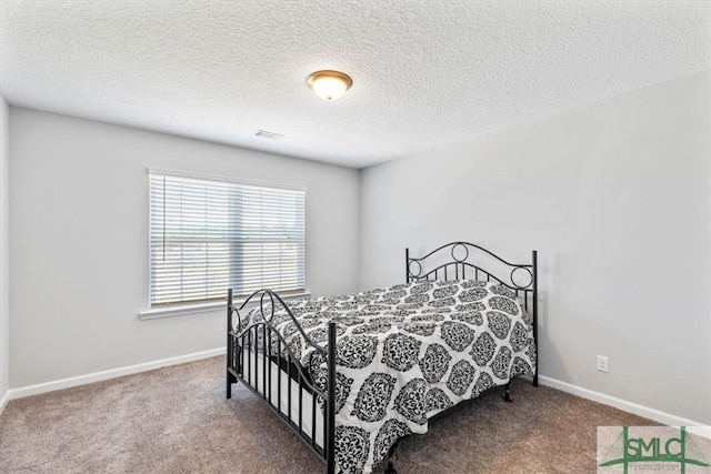 carpeted bedroom with a textured ceiling