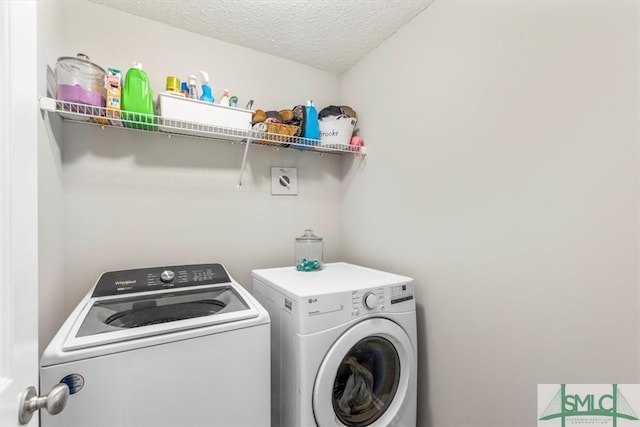 washroom featuring independent washer and dryer and a textured ceiling