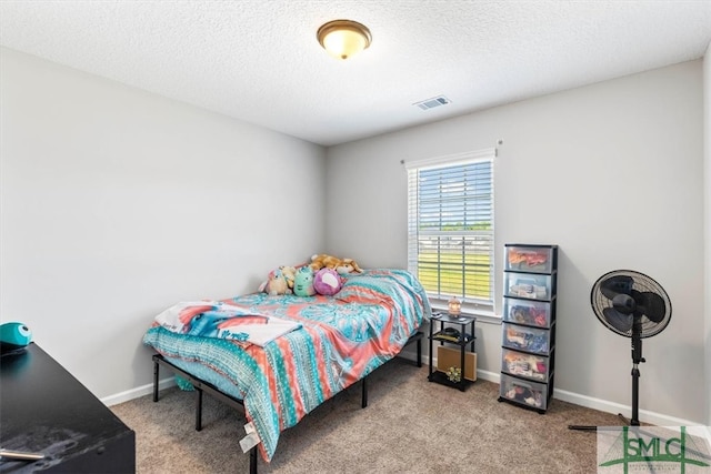 bedroom featuring carpet floors and a textured ceiling