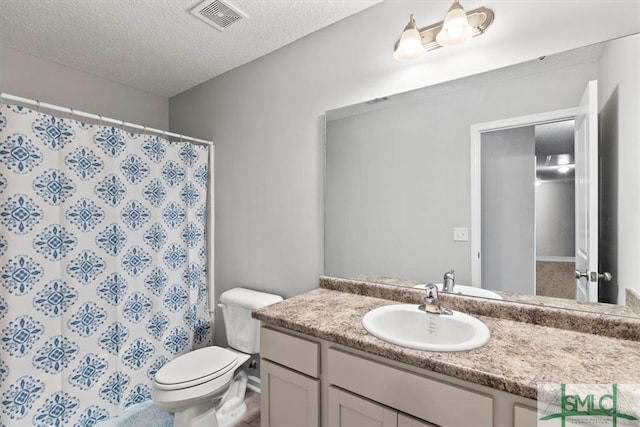 bathroom featuring oversized vanity, toilet, and a textured ceiling