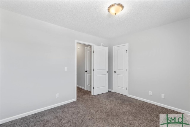 unfurnished bedroom featuring carpet floors and a textured ceiling