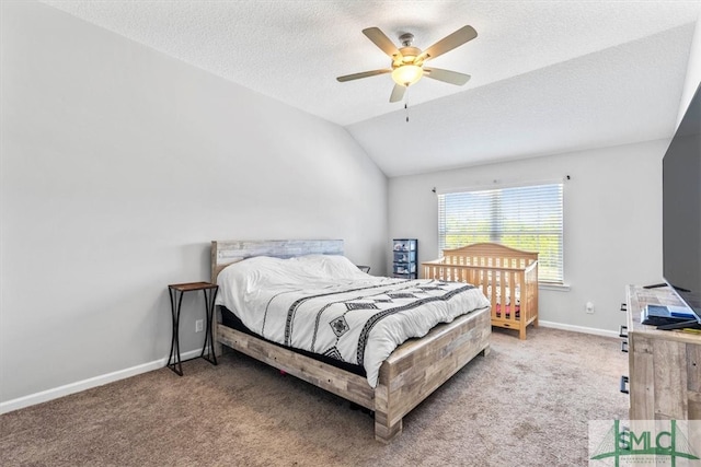 bedroom featuring a textured ceiling, lofted ceiling, carpet floors, and ceiling fan