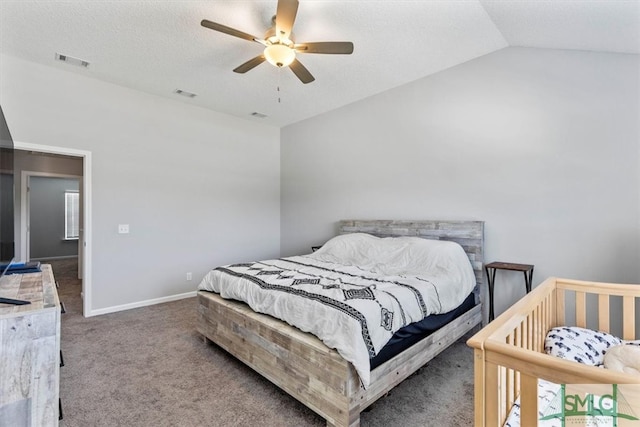 bedroom with a textured ceiling, carpet floors, ceiling fan, and vaulted ceiling