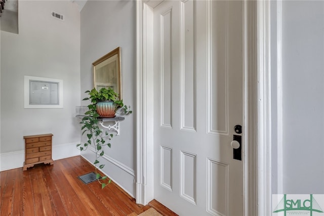 corridor with hardwood / wood-style flooring