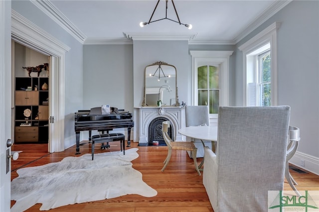 dining area featuring ornamental molding and hardwood / wood-style floors