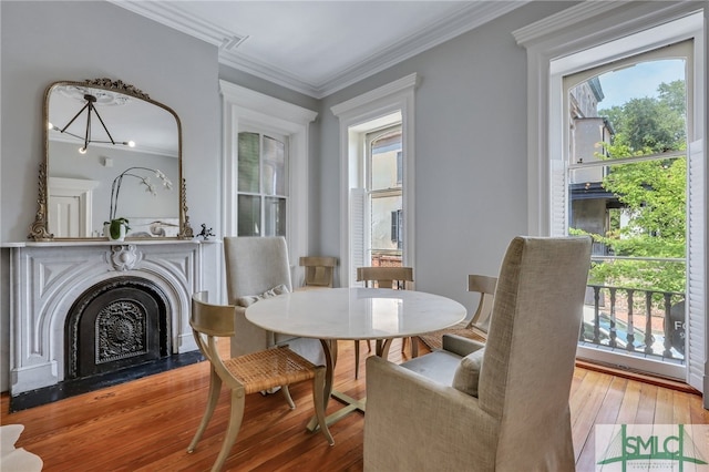 dining room featuring an inviting chandelier, crown molding, and wood-type flooring