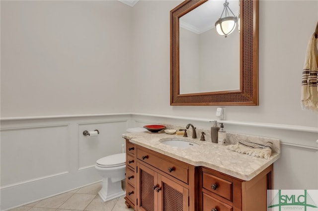 bathroom featuring tile patterned floors, vanity, toilet, and ornamental molding