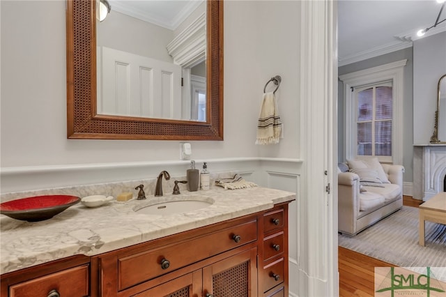 bathroom featuring vanity, hardwood / wood-style floors, and crown molding