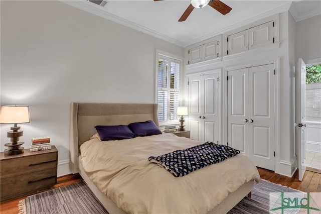 bedroom featuring ceiling fan, ornamental molding, and hardwood / wood-style flooring