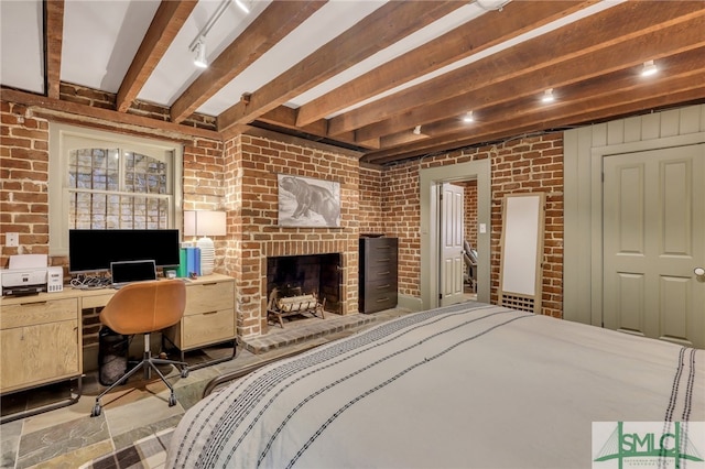 bedroom with beamed ceiling, a fireplace, and brick wall