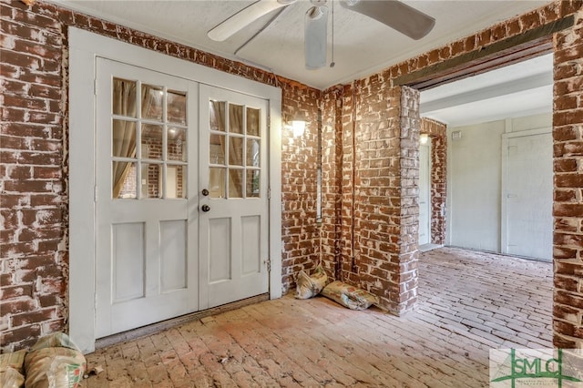 view of exterior entry featuring ceiling fan and french doors