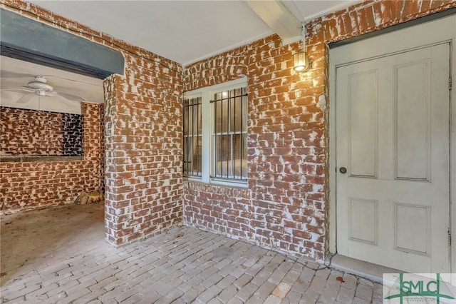 view of exterior entry with ceiling fan