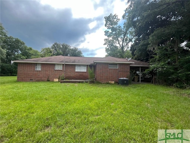 back of house with a yard and a carport