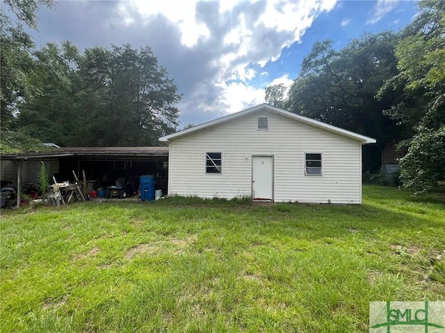 rear view of house featuring a yard