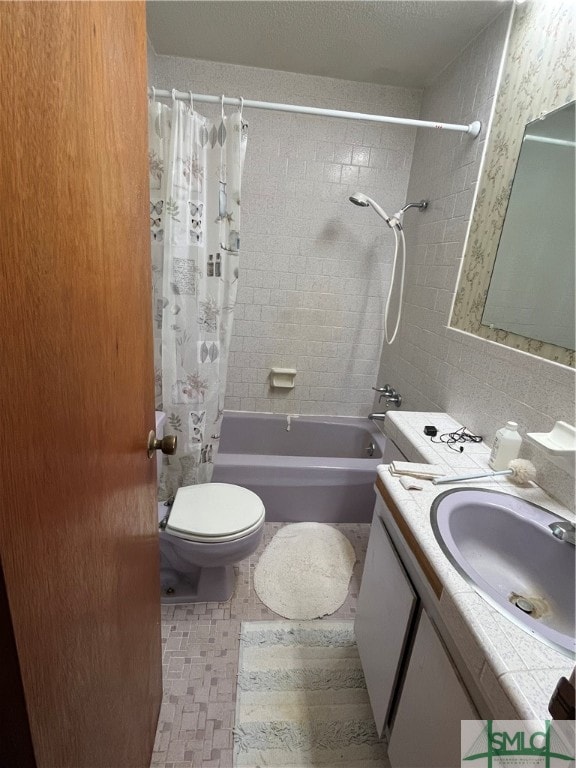 full bathroom with vanity, toilet, shower / bath combo with shower curtain, tile walls, and tasteful backsplash