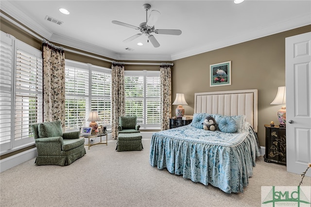 carpeted bedroom with ornamental molding and ceiling fan