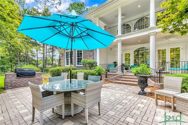 view of patio / terrace featuring a balcony, ceiling fan, and french doors