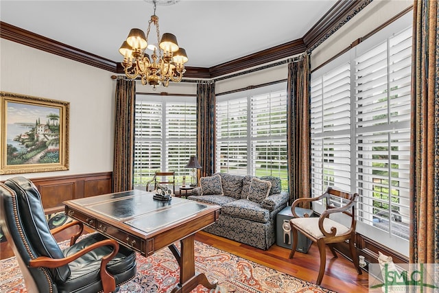 office space featuring a notable chandelier, ornamental molding, and hardwood / wood-style flooring