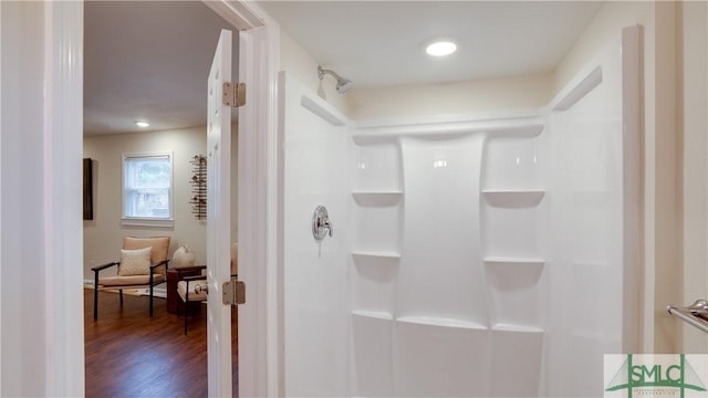 bathroom featuring a shower and wood finished floors