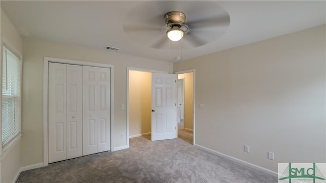 unfurnished bedroom with carpet floors, visible vents, baseboards, and a closet